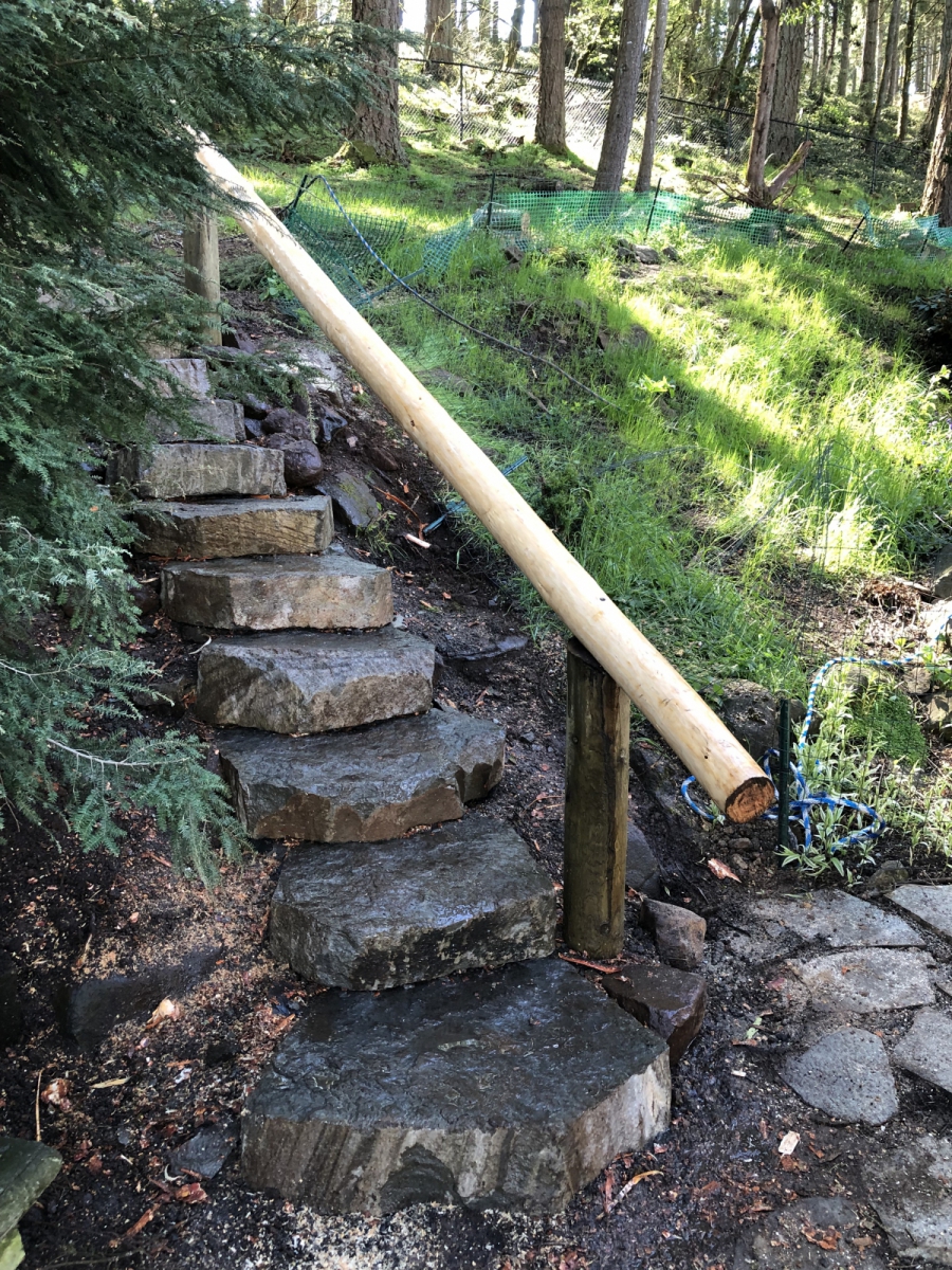 Stone slab steps w/timber railing harvested from windfall on site.